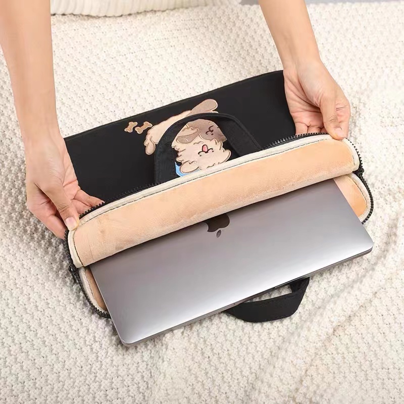 How do the shock-absorbing structure inside the computer bag and the puppy embroidery on the outside work together to ensure both protection and aesthetics?